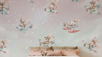 Playful bunnies flying airplanes in the sky-themed wallpaper.