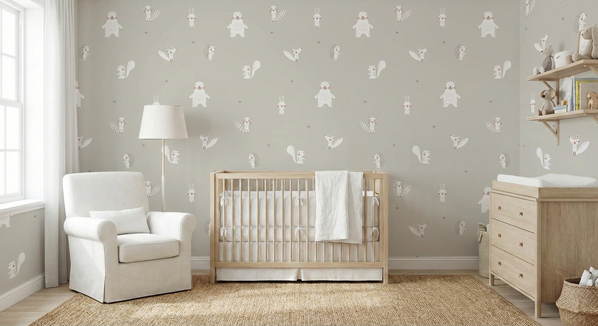 White Color Forest Animals wallpaper in pale grey-green behind a light wood crib and white nursery armchair