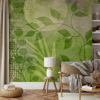 Green and beige mural wallpaper with soft plant shapes

