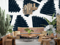 Abstract Indigo wallpaper mural of brushed navy fan shapes on white behind a live-edge wood bench in a boho lounge