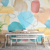 Abstract Shapes in Watercolor colorful wallpaper mural styled as a feature wall behind a dining table and chairs