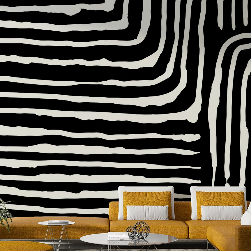 Abstract Stripe wallpaper mural in bold black and white behind a mustard-yellow sofa in a modern living room