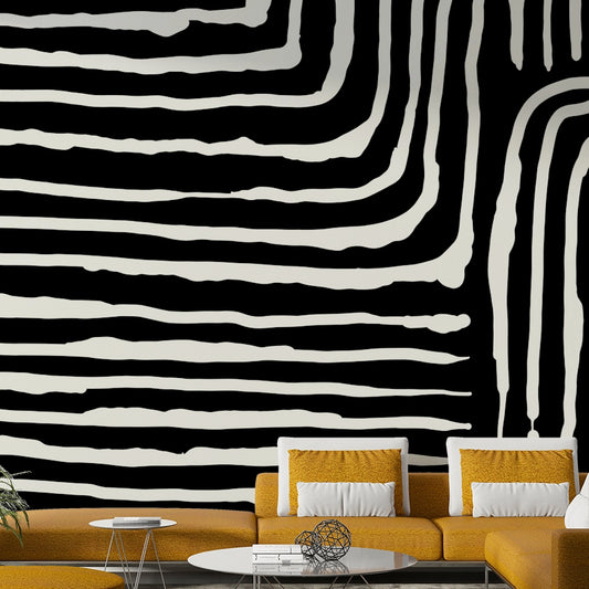 Abstract Stripe wallpaper mural in bold black and white behind a mustard-yellow sofa in a modern living room