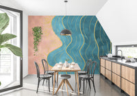Abstract Wave with Gold Line wallpaper mural in coral and teal behind a wooden table and black chairs in a kitchen