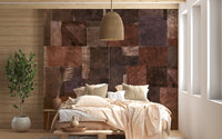 Abstract Wooden Mosaic wallpaper mural of earthy wood-tile patchwork behind a low bed with beige bedding in a boho bedroom
