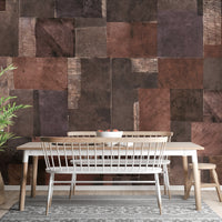 Abstract Wooden Mosaic wallpaper mural of brown patchwork wood tiles behind a wooden dining table and white bench in a dining room