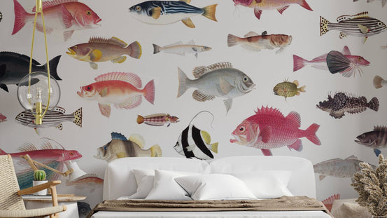 Acquarium wallpaper with vintage illustrated fish on cream behind a white upholstered bed in a cozy bedroom