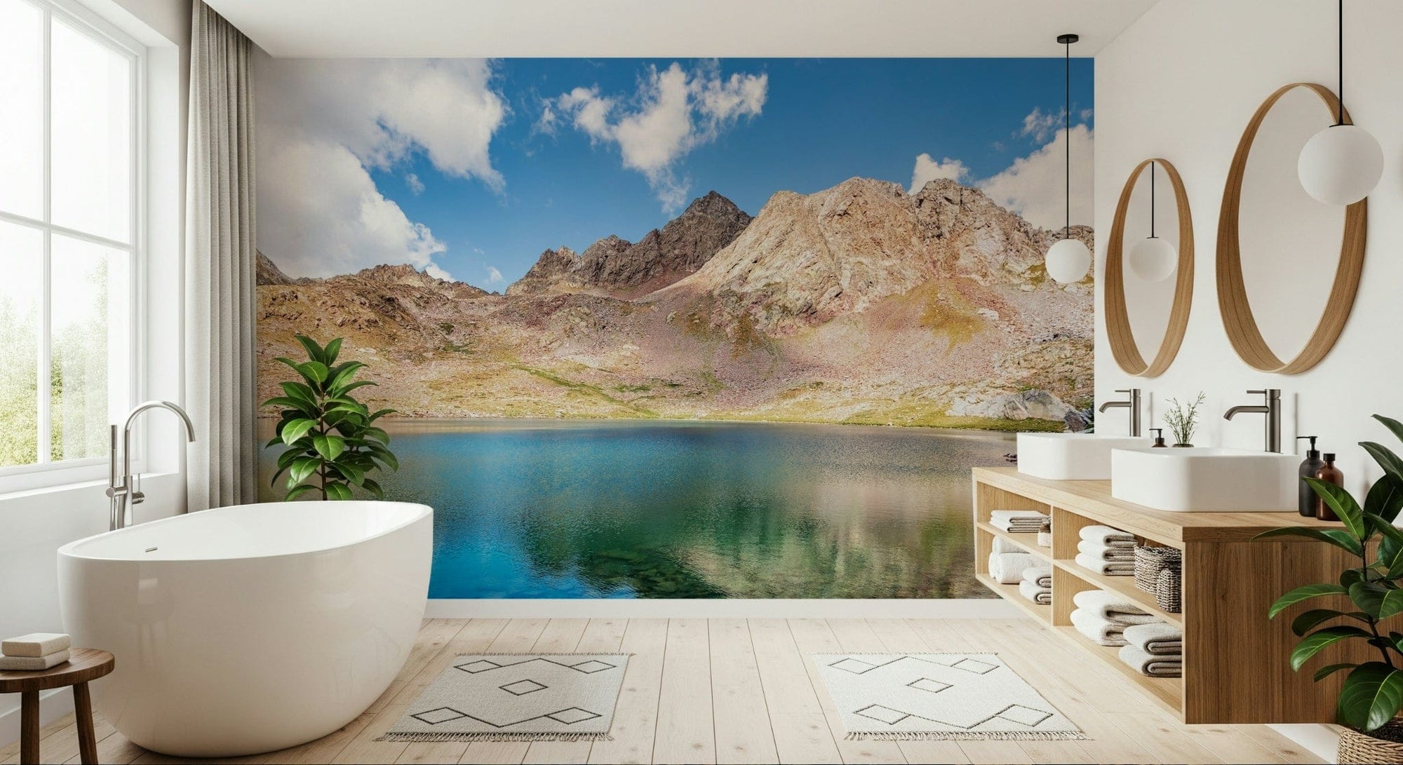 Alpine Azure wallpaper mural of a turquoise mountain lake and rocky peaks behind a freestanding white bathtub in a bathroom