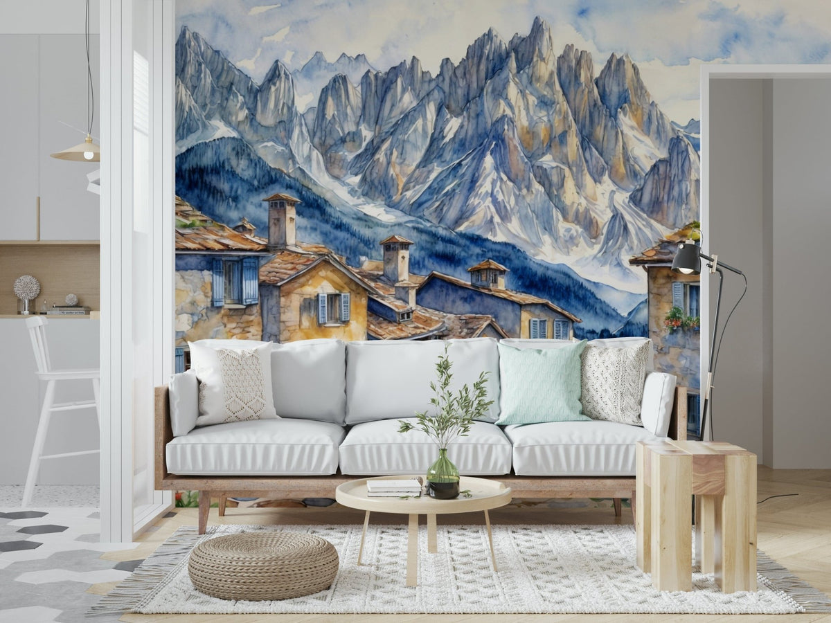 Alpine Village Dream wallpaper mural, watercolor stone village and snowy peaks behind a white sofa in a living room