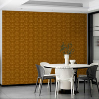 Amber Hues wallpaper in warm ochre behind a white round dining table with black and white chairs