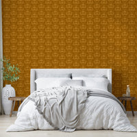 Amber Hues wallpaper in mustard damask above a white bed with a grey throw and wood side benches
