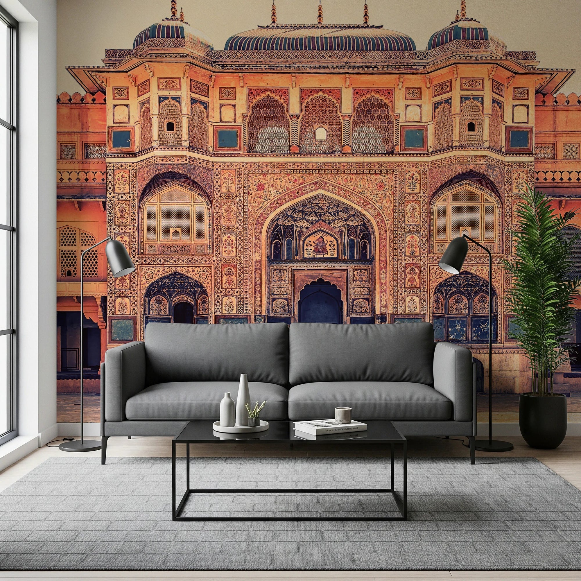 Amber Palace Grandeur wallpaper mural of an ornate amber Indian palace facade behind a gray sofa in a living room