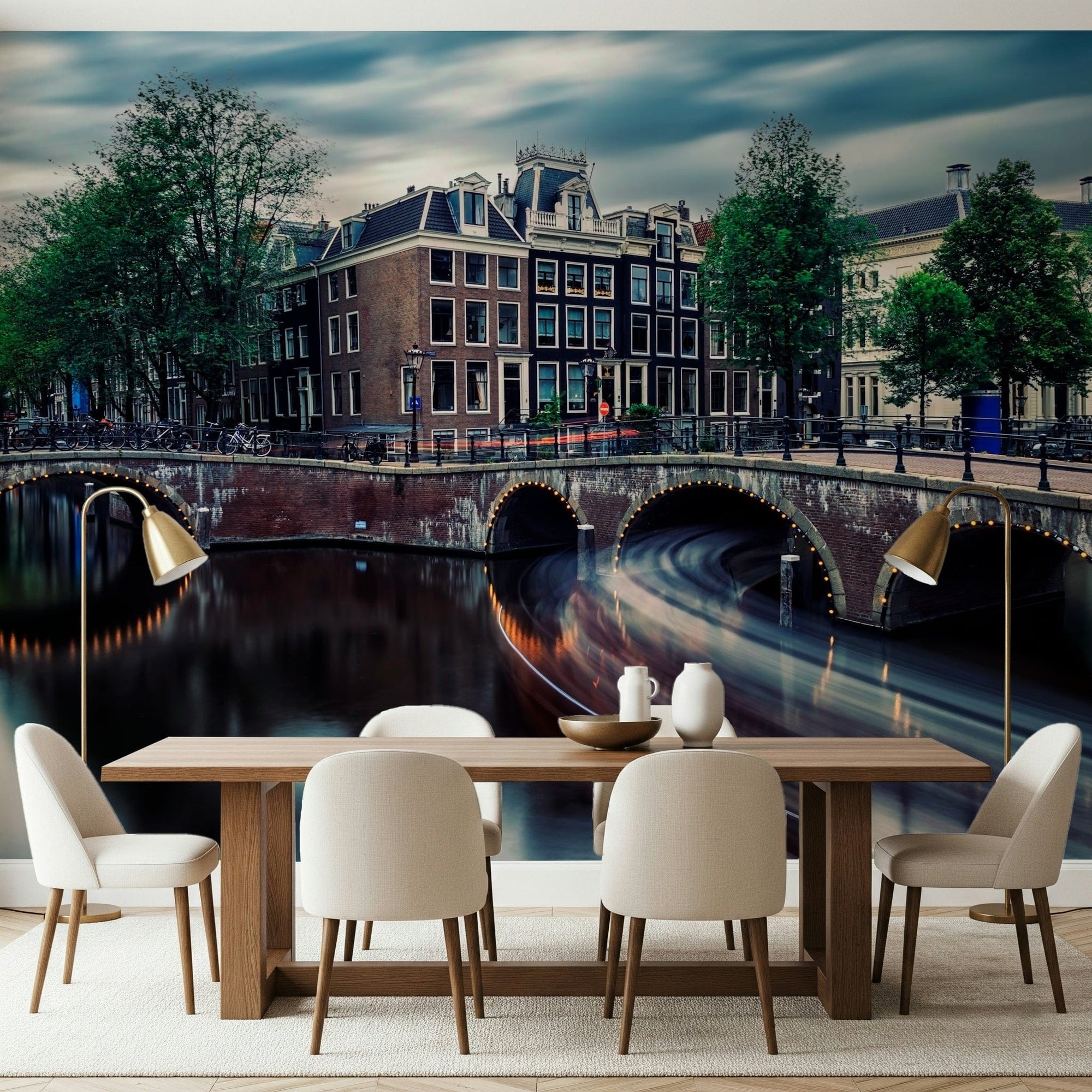 Amsterdam Canal Dreams wallpaper mural of lit canal bridges and Dutch houses above a wood dining table in a dining room