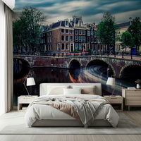 Amsterdam Canal Dreams wallpaper mural of the dusk canal and Dutch houses behind a white bed and lamps in a bedroom