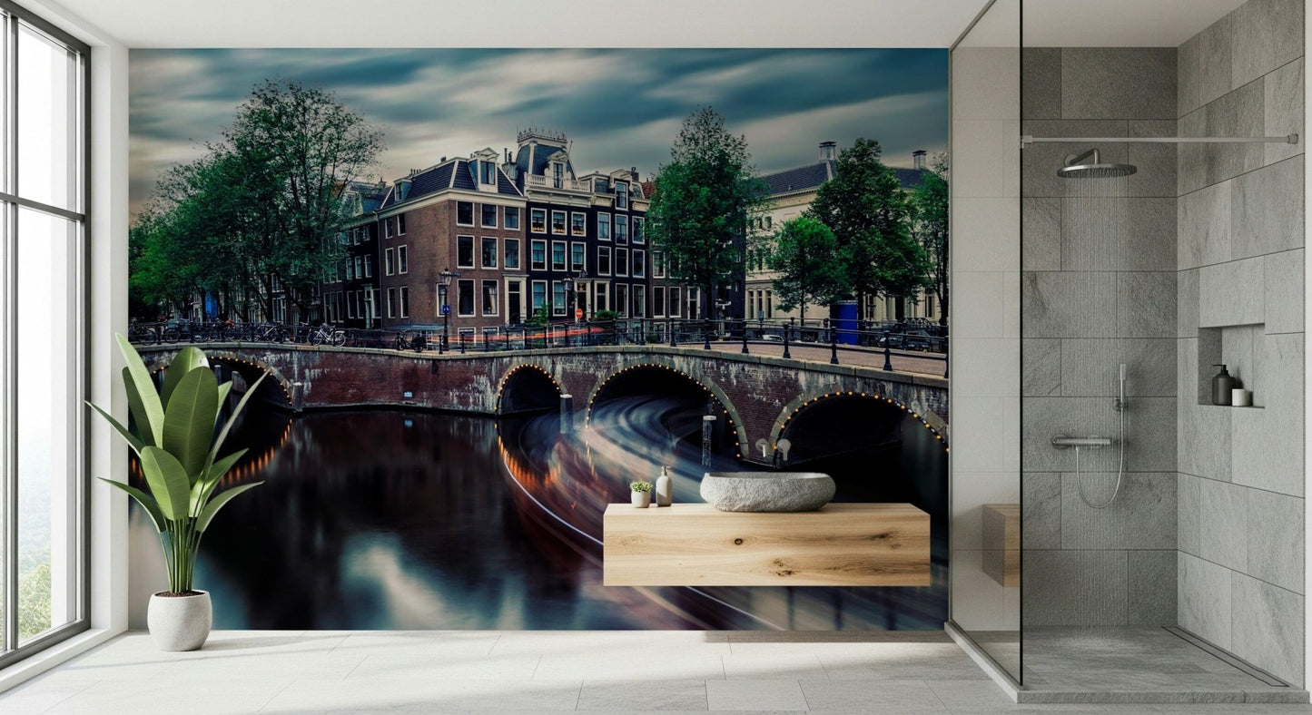 Amsterdam Canal Dreams wallpaper mural of the canal at dusk beside a wood floating vanity in a grey-tiled bathroom