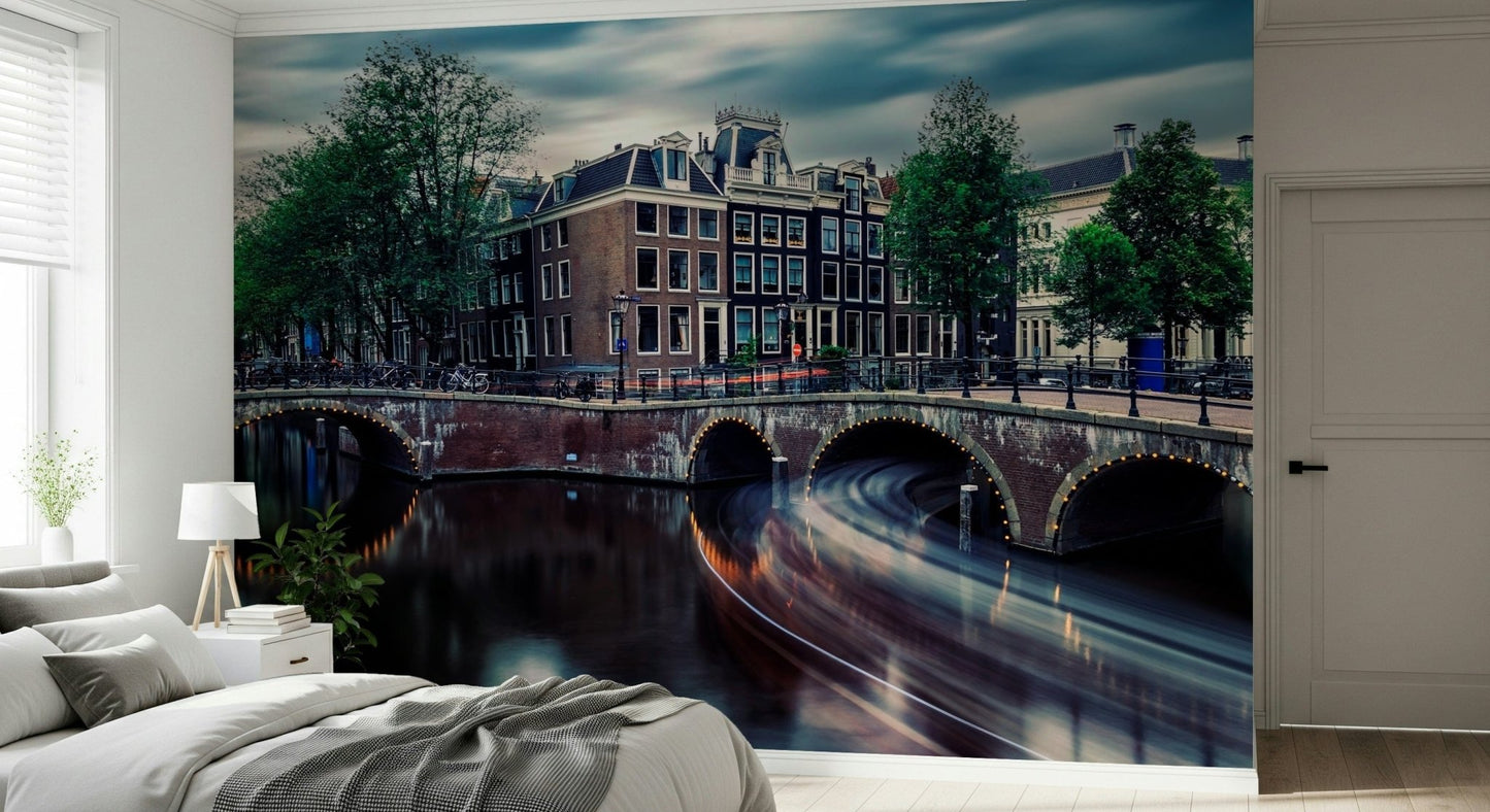 Amsterdam Canal Dreams wallpaper mural of the canal at dusk behind a white bed and nightstand in a calm bedroom