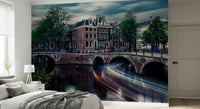 Amsterdam Canal Dreams wallpaper mural of the canal at dusk behind a white bed and nightstand in a calm bedroom