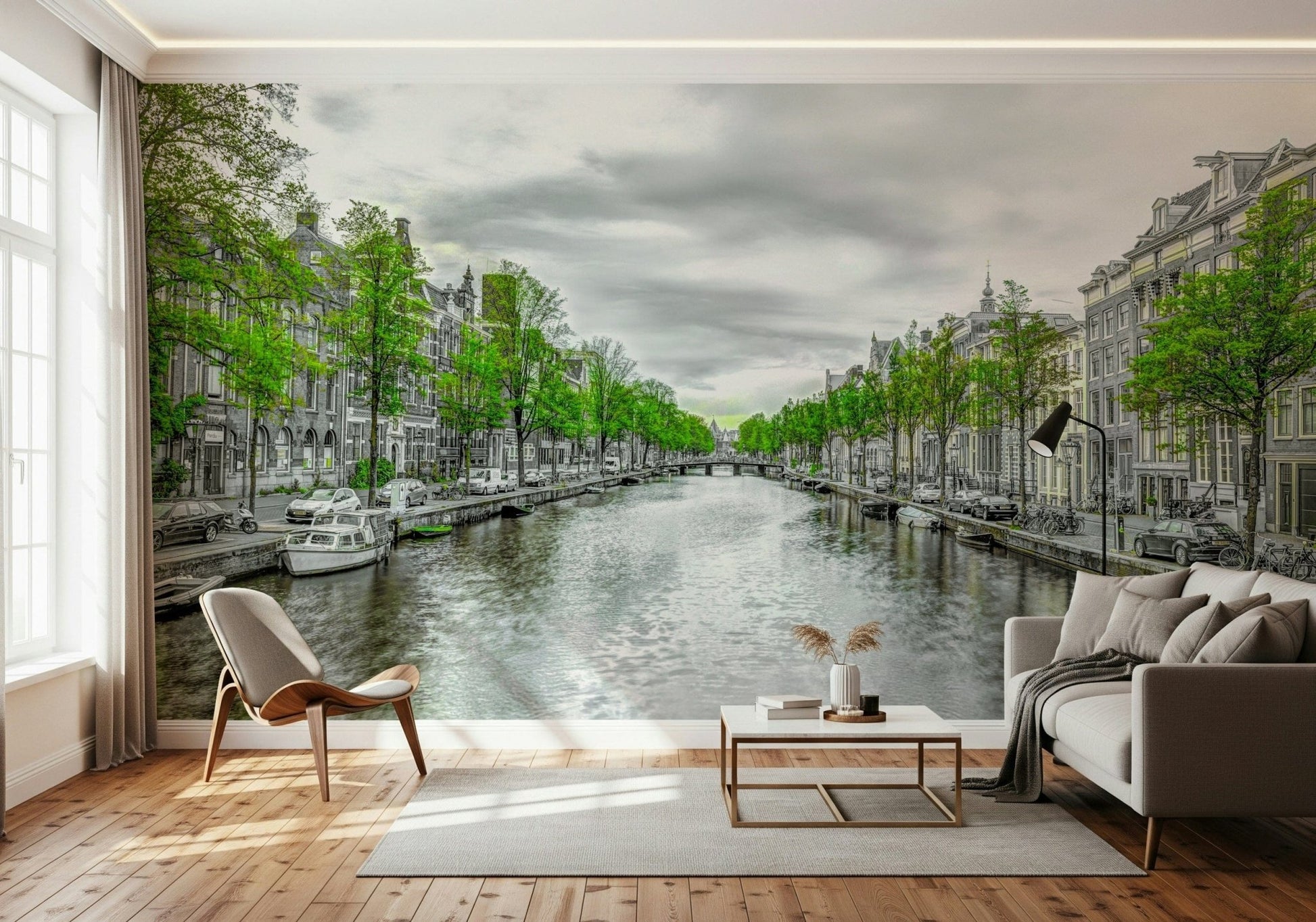Amsterdam Canal Serenity wallpaper mural of a green-trimmed canal behind a gray sofa and wood chair in a living room