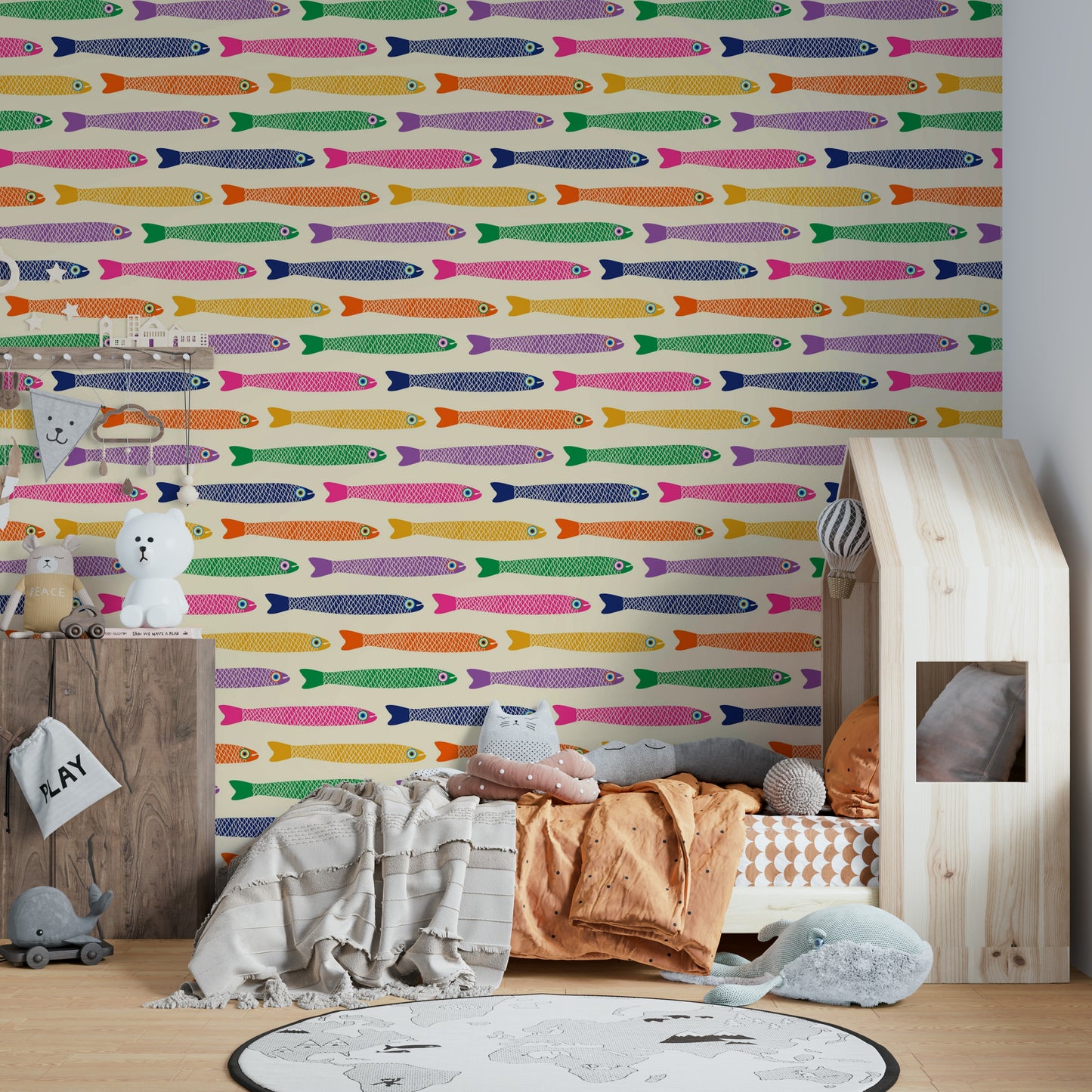 Rainbow-colored fish design on cream wallpaper for children’s rooms.


