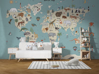 Animal Adventure Atlas wallpaper mural behind a white sofa with owl plush toys and a wooden ladder shelf in a kids room