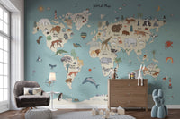 Animal Adventure Atlas wallpaper mural in teal behind a grey velvet armchair and wooden dresser in a bright living room