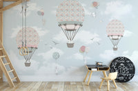 Animated Animals Sky wallpaper mural as a bedroom feature wall behind the headboard in pink tones