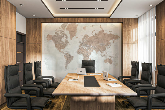 Antique World Map Watercolor wallpaper in sepia behind a long wood conference table and black chairs in a boardroom