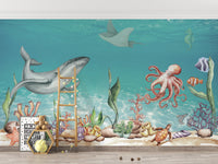 Aquatic Harmony wallpaper mural with a gray whale, red octopus and turtle in turquoise water in a kids room with a ladder shelf