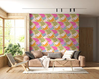 Art Nouveau Botanica Fan Flow Bloom Burst wallpaper behind a tan leather sofa and woven chair in a living room