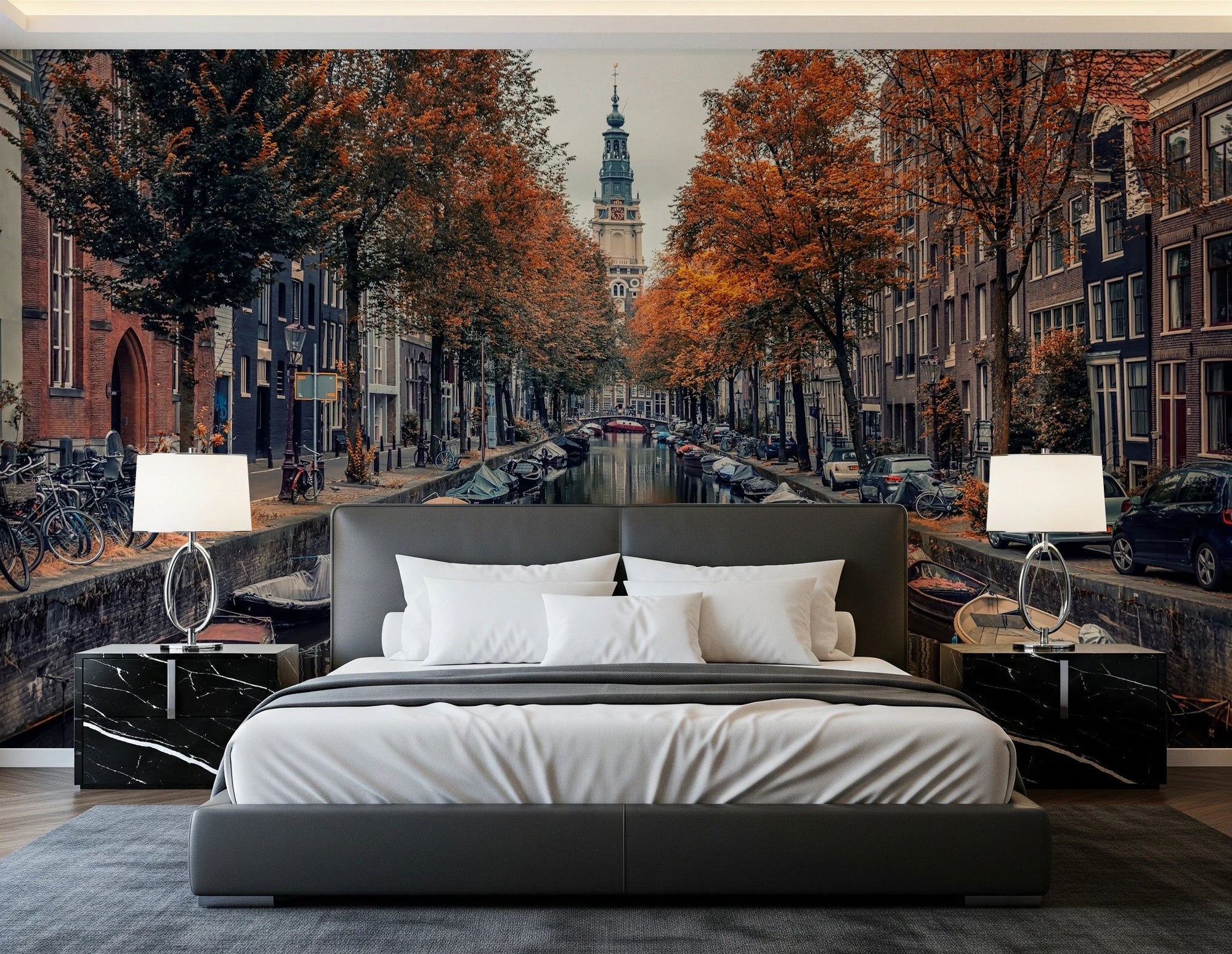 Autumn Canal Charm wallpaper mural of an autumn canal behind a grey leather bed and marble nightstands in a bedroom