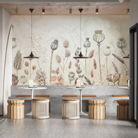 Autumn Flowers wallpaper mural of dried poppy pods behind concrete bench seating and rattan stools in a cafe
