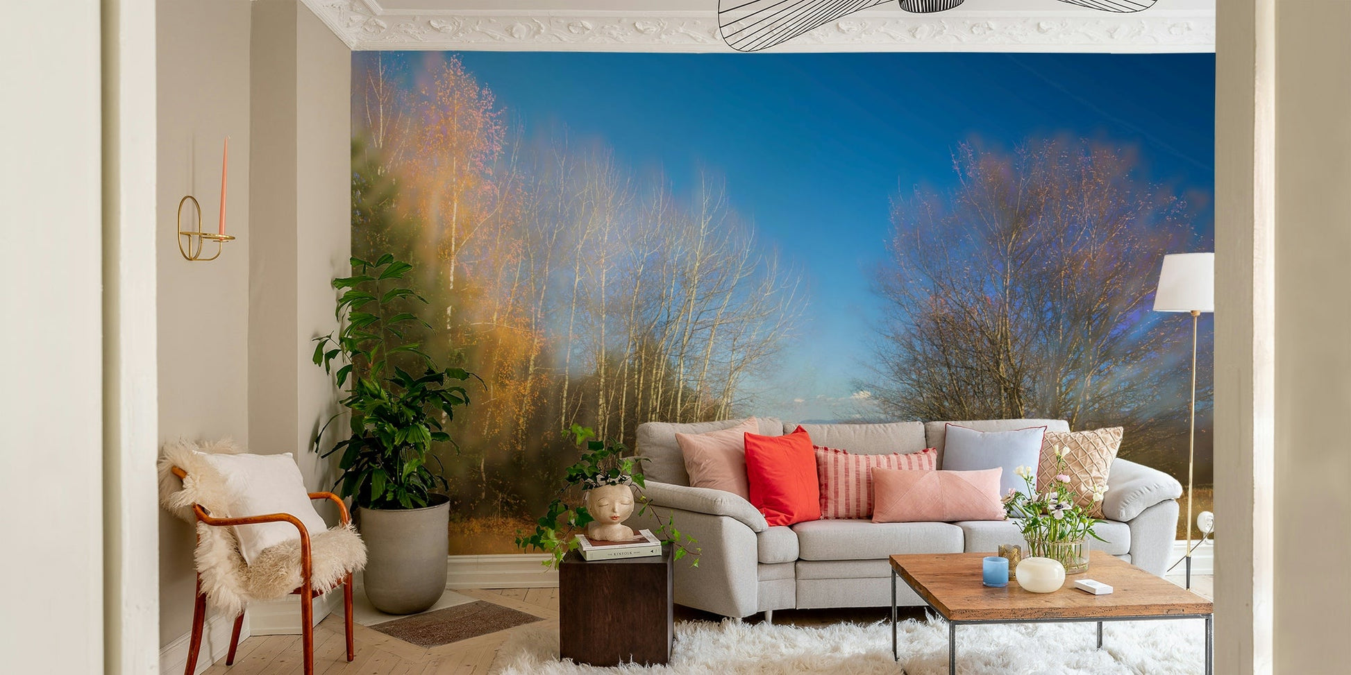 The mural is the main feature on a wall behind a light-colored sofa.

