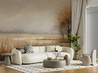 Autumn Vista wallpaper mural of a hazy autumn meadow behind a curved cream sofa and taupe coffee table in a living room