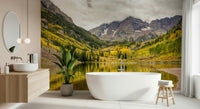 Reading nook with autumn lake mural wallpaper, soft chair, warm color accents