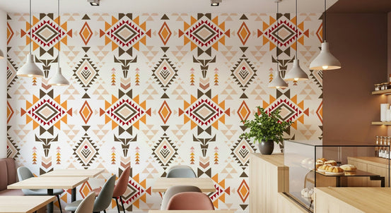Aztec Echo wallpaper with orange and brown tribal diamonds in a cafe with pendant lights and pastry counter