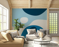 A soothing abstract wallpaper featuring flowing shapes in deep navy, sky blue, and soft white tones.