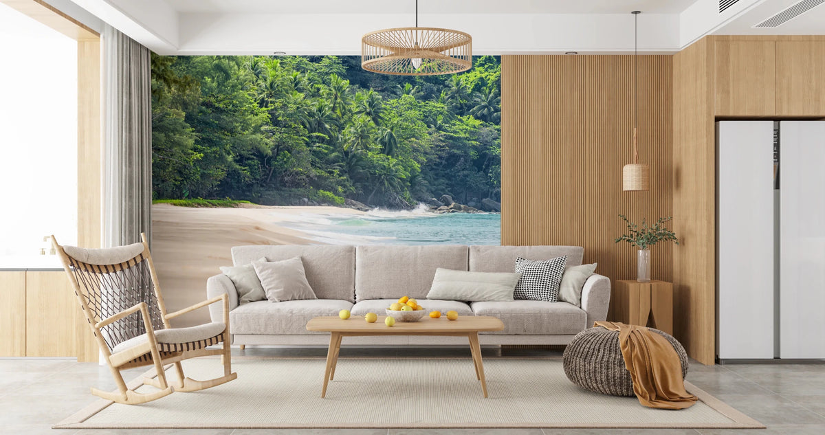 Beach Haven wall mural of a sandy cove and green jungle behind a cream sofa and wood rocking chair in a living room
