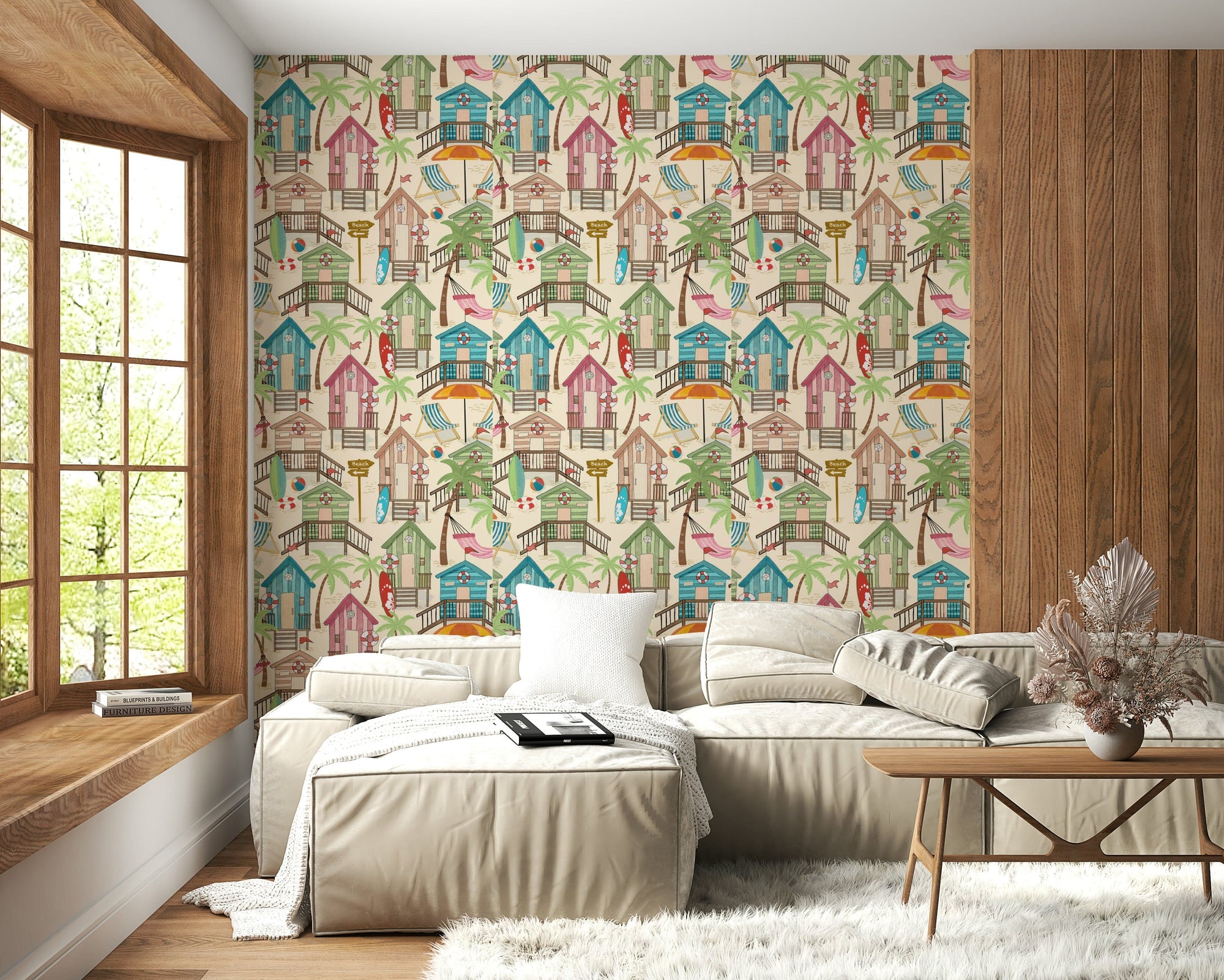 Beach Huts Bliss wallpaper with colourful seaside cabins behind a beige sectional sofa in a cosy living room