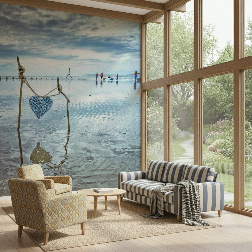 Beach Love wall mural of a blue wicker heart on driftwood by the sea behind a striped sofa and patterned armchair