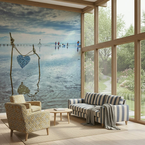 Beach Love wall mural of a blue wicker heart on driftwood by the sea behind a striped sofa and patterned armchair
