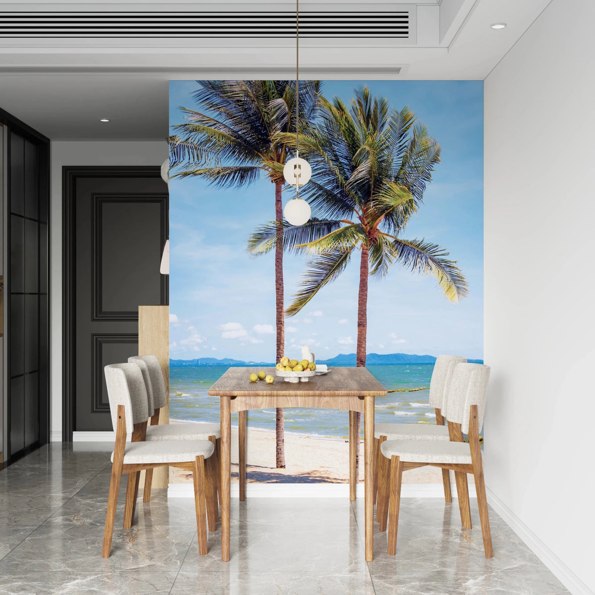 Beachfront Bliss wallpaper mural of two palm trees on a tropical beach behind a wood dining table and cream chairs