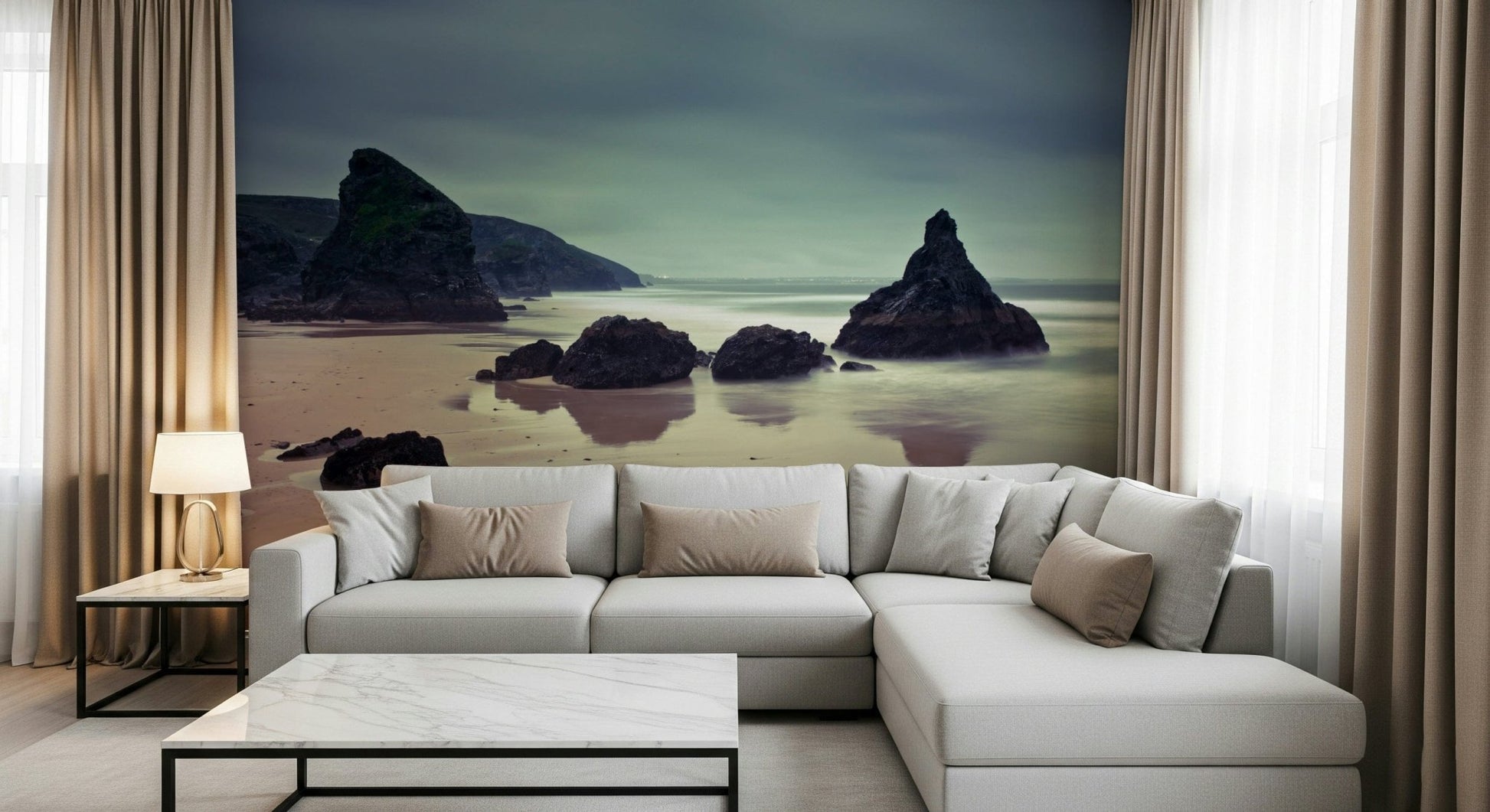 Calm beach landscape mural behind white living room sofa