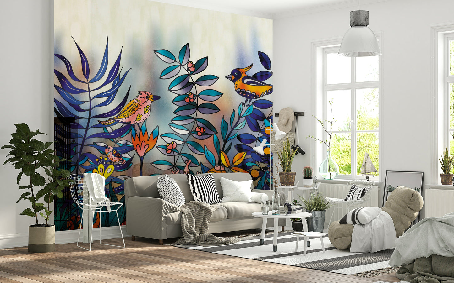 Enchanted Birds Forest wallpaper mural behind a grey sofa, vivid birds and blue foliage in a bright living room