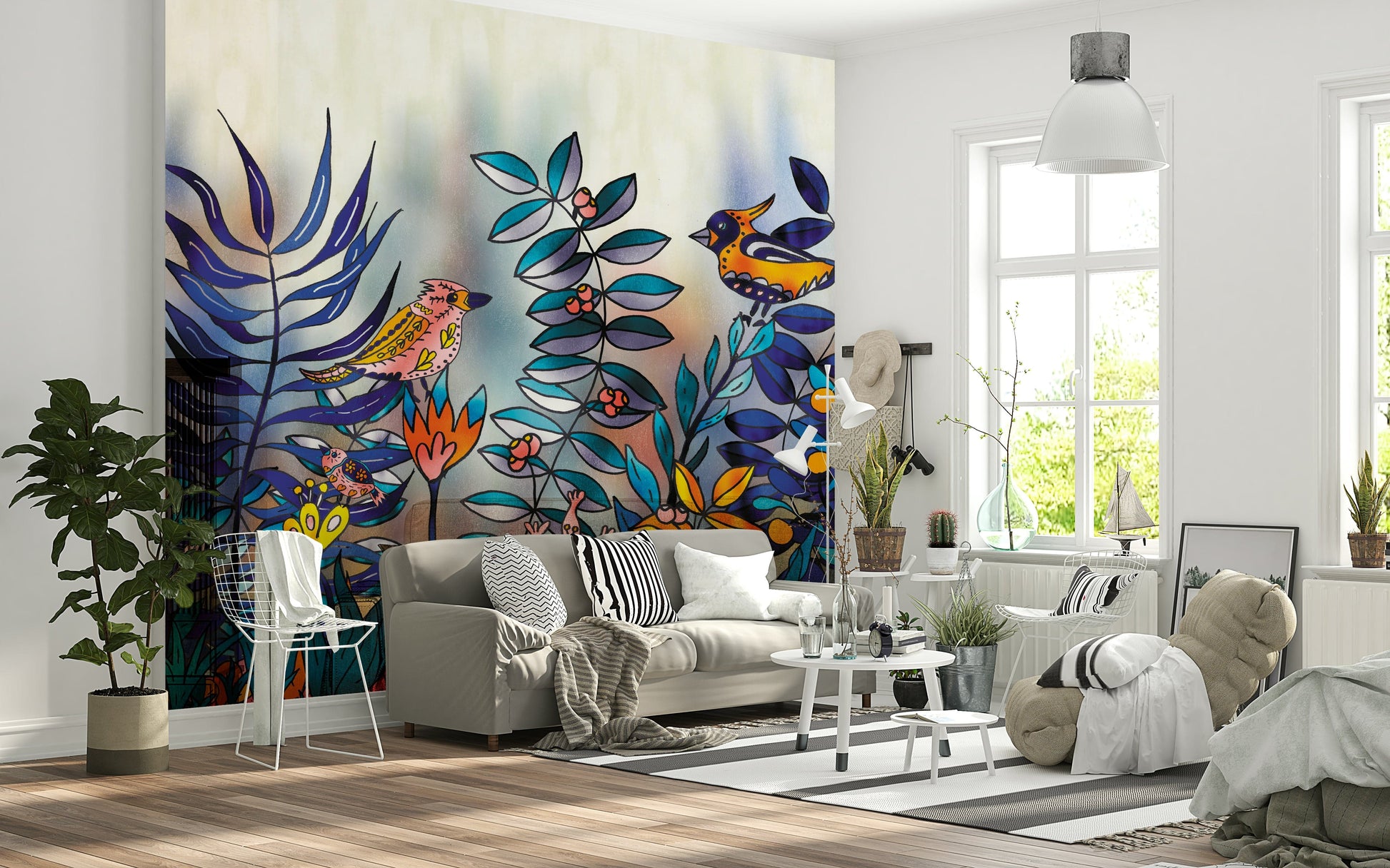 Enchanted Birds Forest wallpaper mural behind a grey sofa, vivid birds and blue foliage in a bright living room