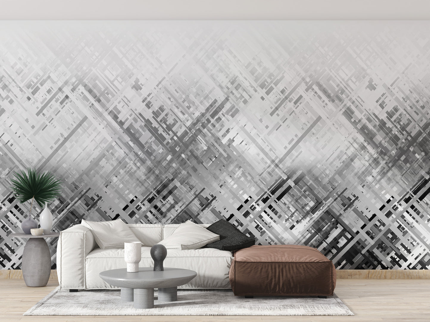 Abstract Diagonal Lines wallpaper mural in grey behind a white sofa and brown leather ottoman in a living room