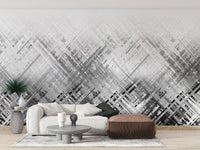 Abstract Diagonal Lines wallpaper mural in grey behind a white sofa and brown leather ottoman in a living room