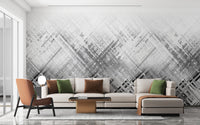 Abstract Diagonal Lines wallpaper mural in grey behind a beige sectional and orange armchair in a living room
