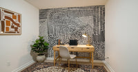 Black And White Maze wallpaper mural behind a wood desk and white chair in a home office