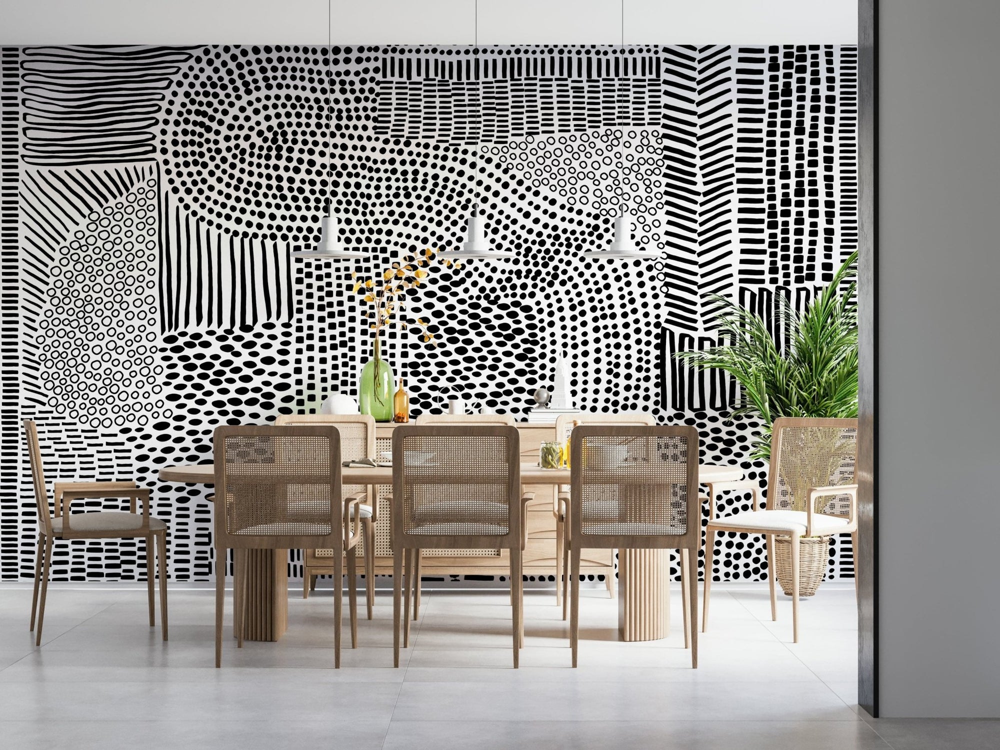 Black And White Maze wallpaper mural behind a wood dining table and cane chairs in a bright room