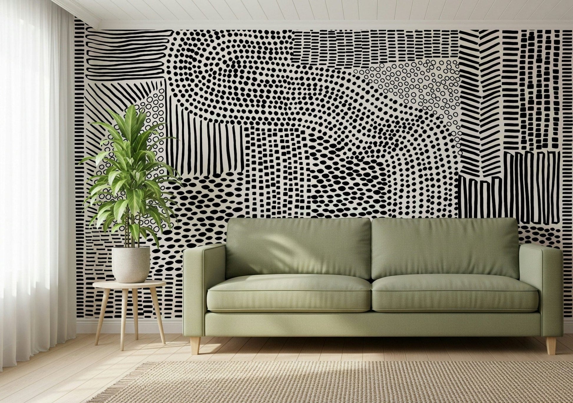 Black And White Maze wallpaper mural behind a sage green sofa and potted plant in a living room